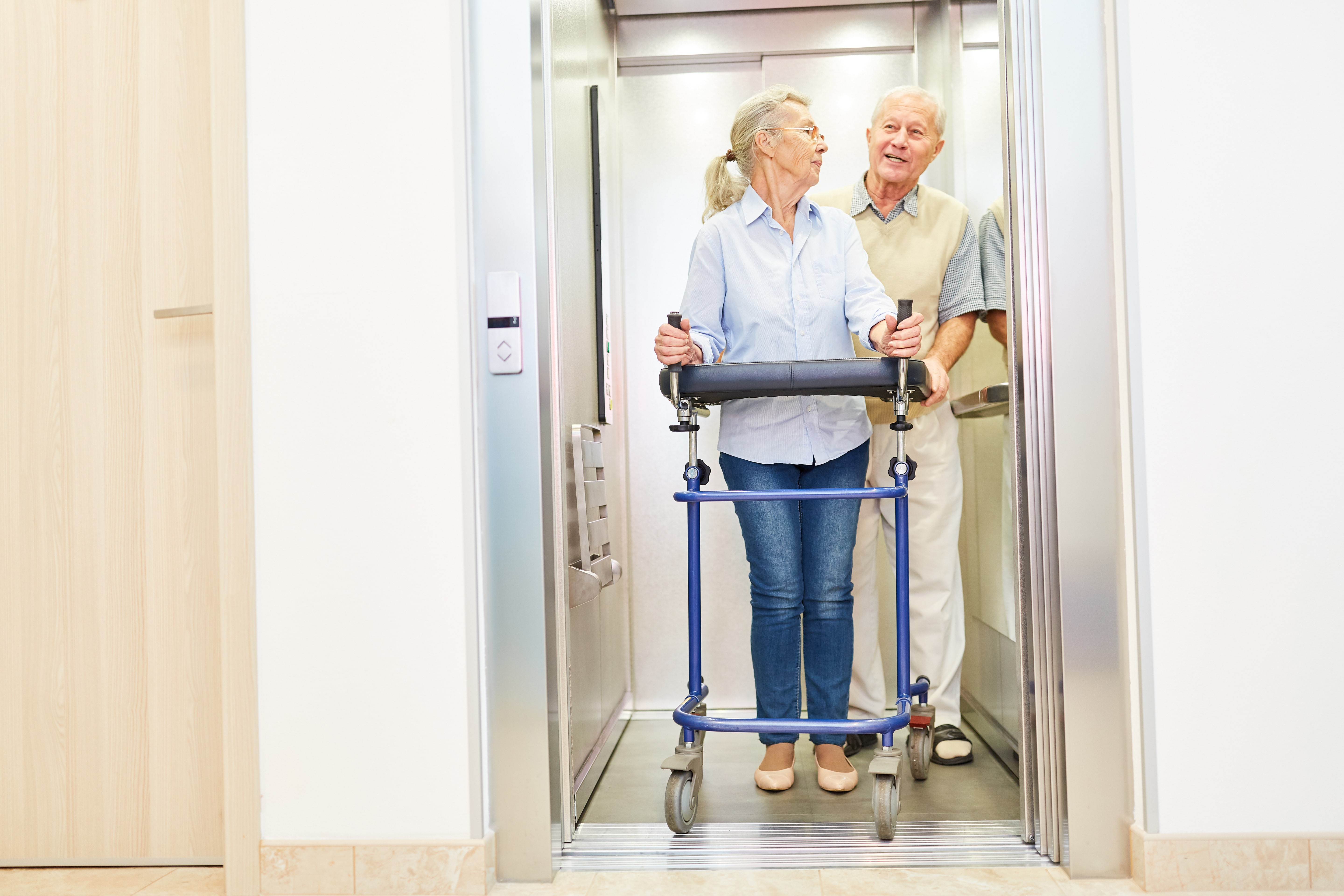 Elderly Couple Using Home Elevator 